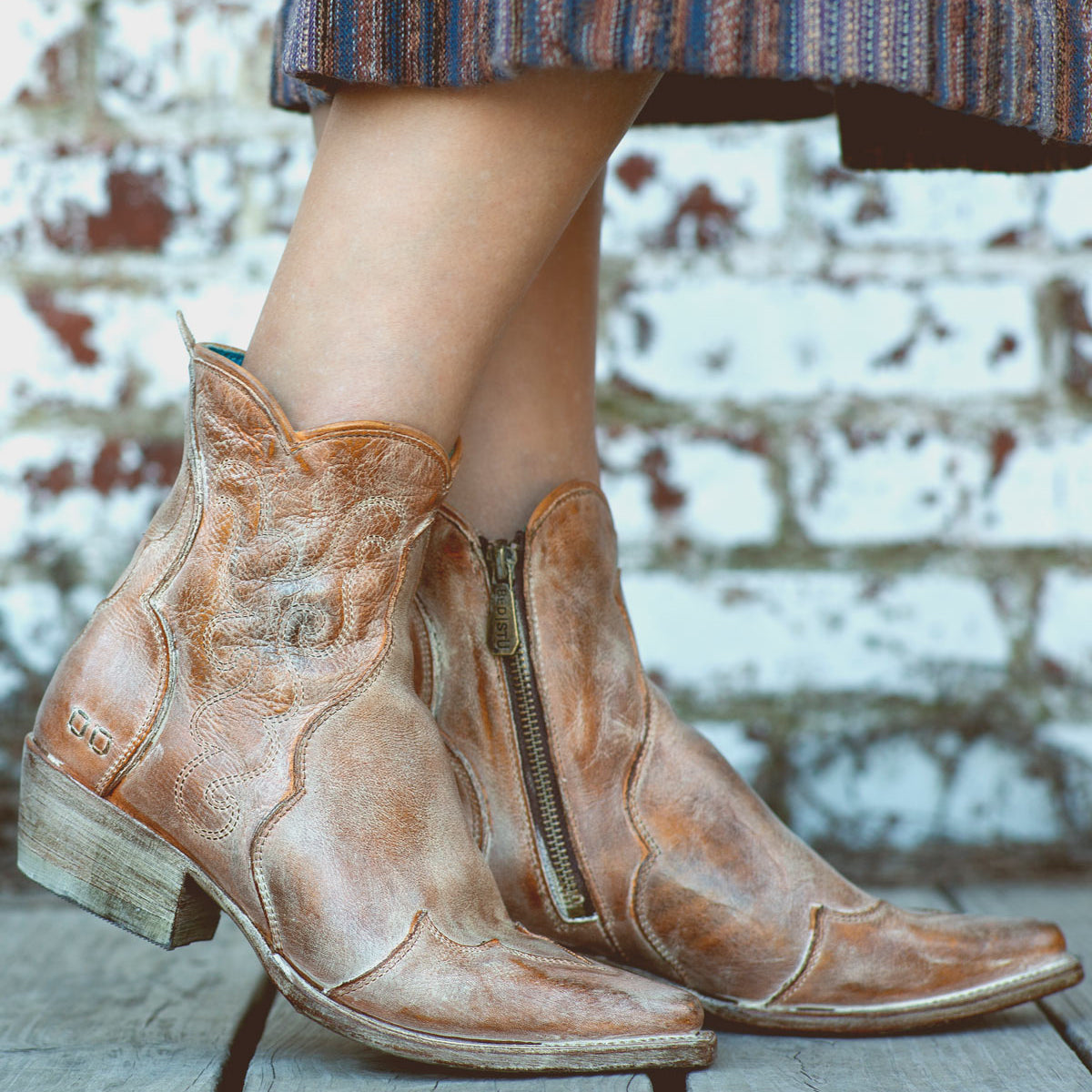 A woman donning a stylish pair of Bed Stu Ace leather cowboy boots.