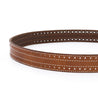 A brown leather belt with silver grommets, the Addison by Bed Stu, lying in a circular shape on a white background.