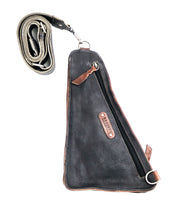 A versatile crossbody bag, the Adept by Bed Stu features a prominent zipper, brown accents, and a branded label in the center. Crafted from vegetable tanned leather, it includes an adjustable, detachable strap, making it the perfect travel companion.