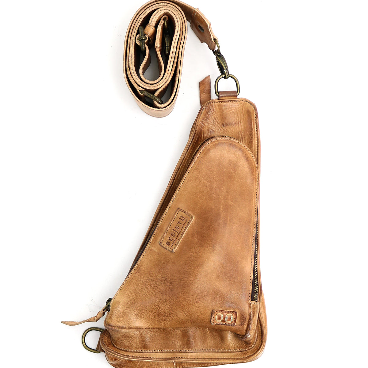 A versatile crossbody bag crafted from vegetable-tanned leather, featuring a zippered main compartment and a detachable, adjustable strap—perfect as your new travel companion, the Adept by Bed Stu.