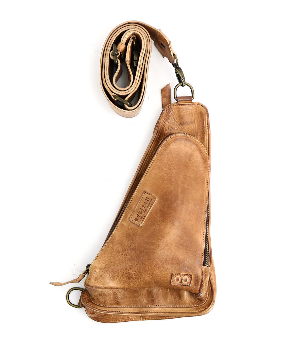 A versatile crossbody bag crafted from vegetable-tanned leather, featuring a zippered main compartment and a detachable, adjustable strap—perfect as your new travel companion, the Adept by Bed Stu.