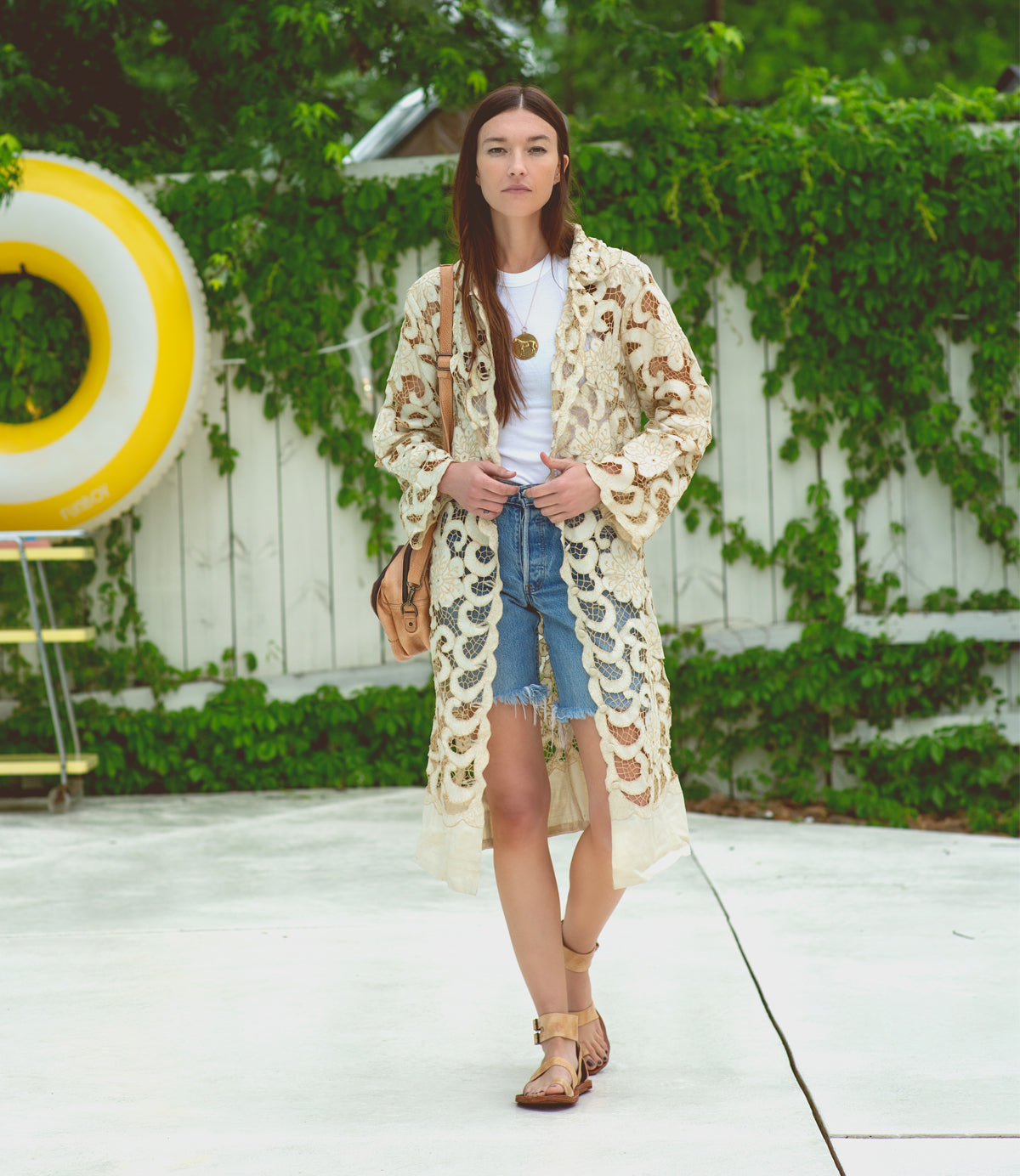 A woman wearing Bed Stu denim shorts and an Afrodita lace kimono.