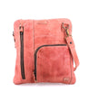 A Bed Stu Aiken pink leather cross body bag with a zipper.