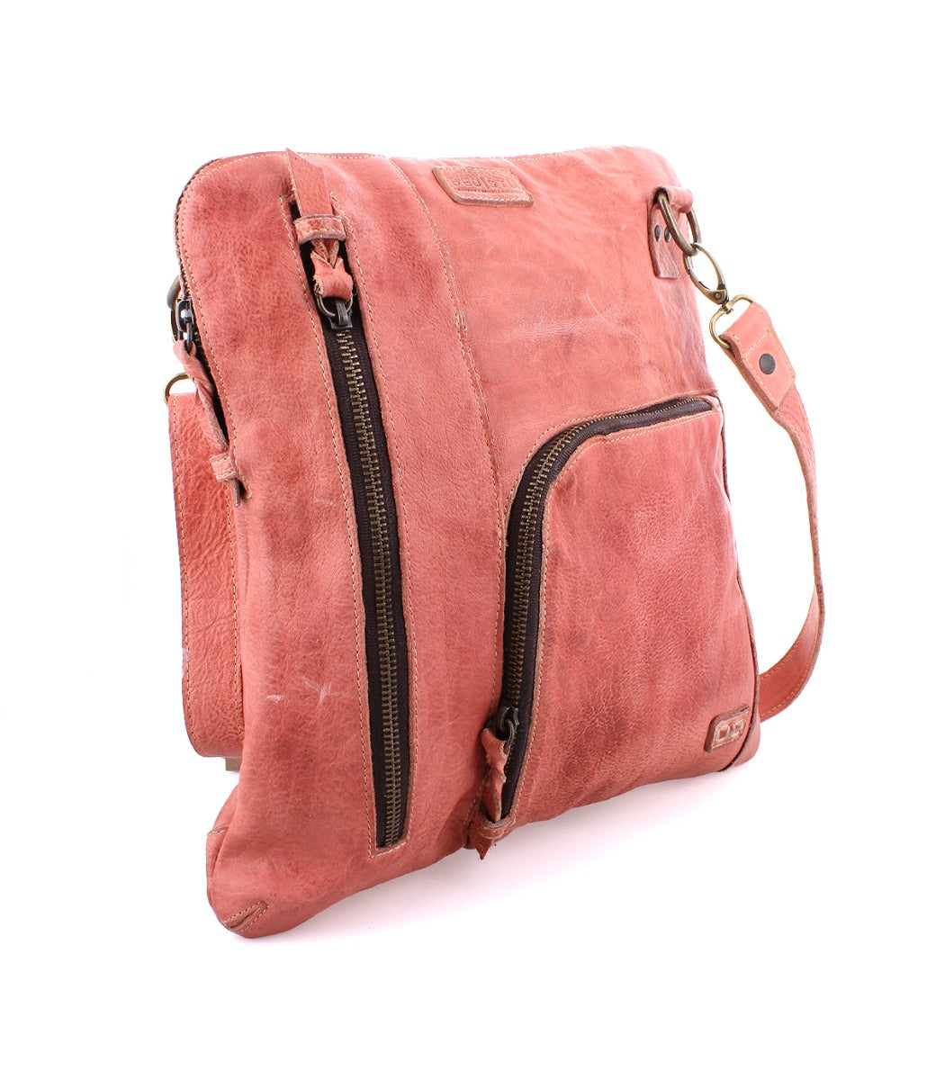 A Bed Stu Aiken pink leather crossbody bag with a zipper.