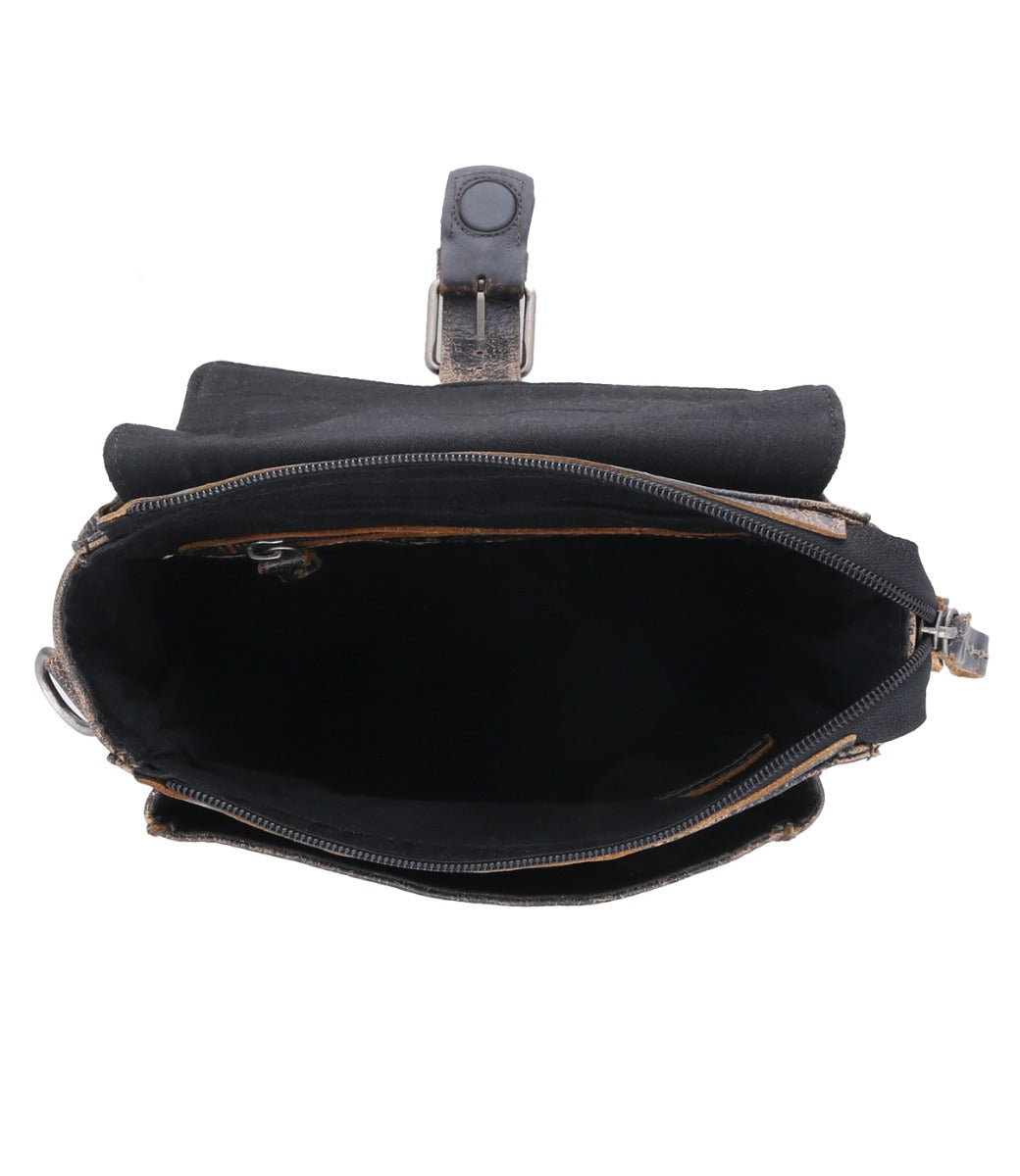 The inside of a Bed Stu black messenger bag with an adjustable and removable strap and zip-top closure.