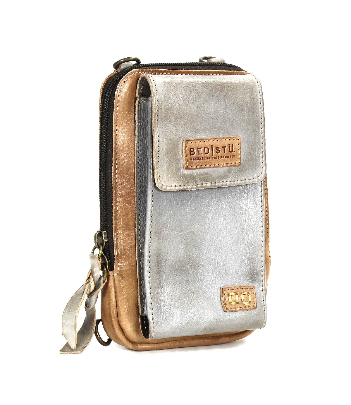 Bed Stu's Alelike is a compact, premium leather crossbody phone holder with a silver front flap, tan sides, zipper closure, and a Bed Stu logo patch on the front pocket.