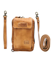 The Alelike, a tan leather crossbody bag by Bed Stu, features a front flap marked "BED/STU." Crafted from premium leather, this versatile piece includes both a detachable wrist strap and an adjustable shoulder strap for everyday practicality.