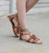 A woman wearing the Bed Stu Alena sandals with tassels.