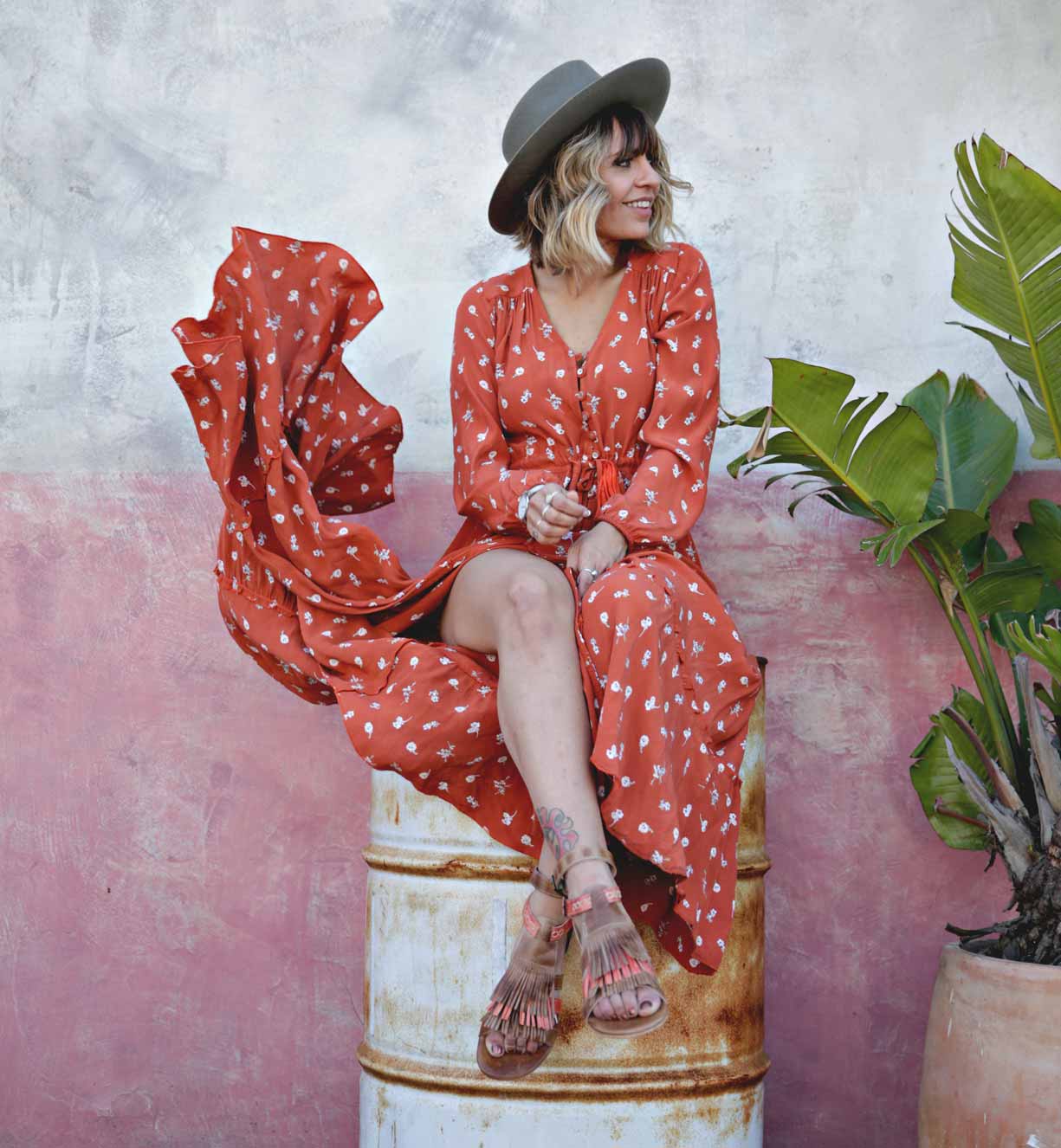 A woman in a red polka dot dress sitting on a Bed Stu Alena pot.