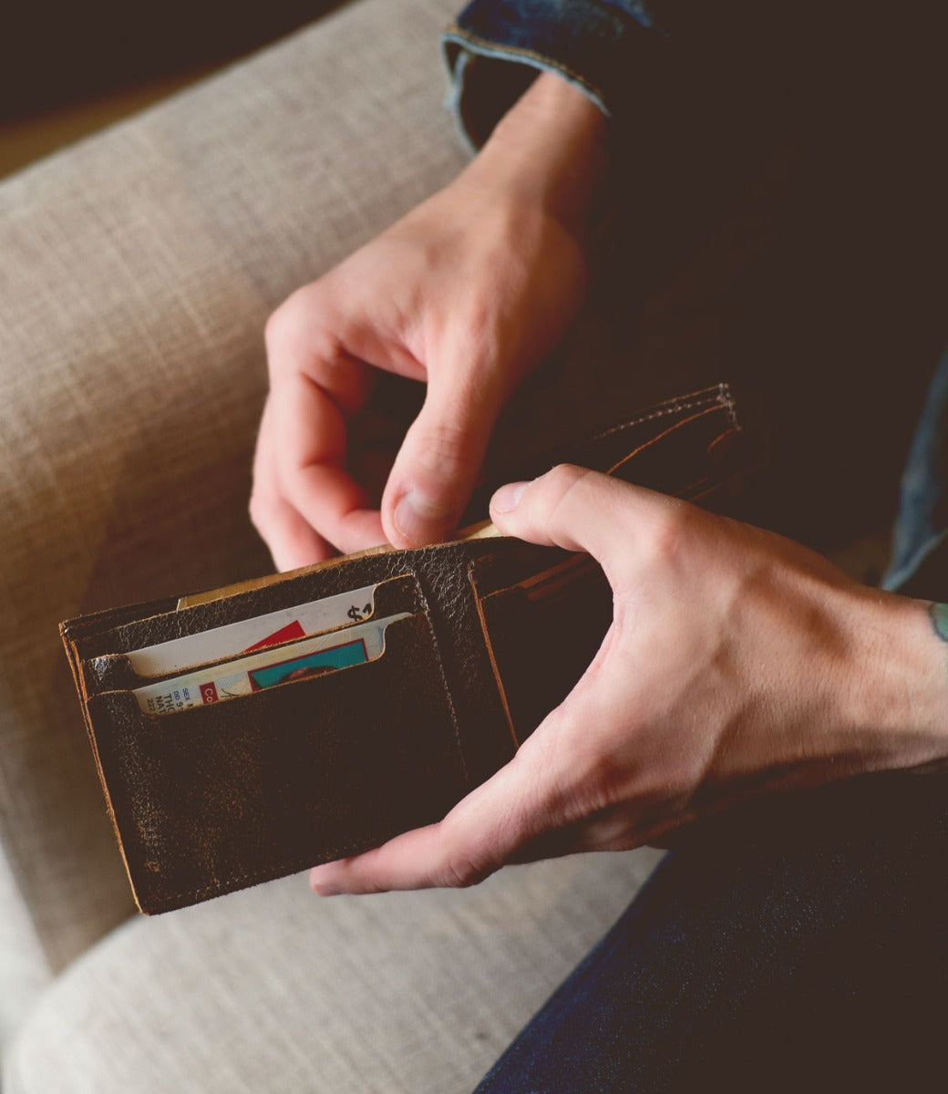 A person holding an Amidala wallet with credit cards in it.