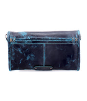 The Amina by Bed Stu is a black leather wallet with blue distressed accents, featuring a zippered outer pocket and a flap closure, perfect for doubling as a sleek clutch.