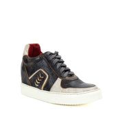 The Andromeda by Bed Stu is a black and beige high-top sneaker with a white sole, red inner lining, and street-smart design featuring a decorative zigzag pattern on the side.