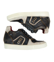 A pair of worn Andromeda high-top sneakers from Bed Stu in black and white, boasting a street-smart design with a distinctive pattern on the side, white rubber soles, and visible wear and tear.