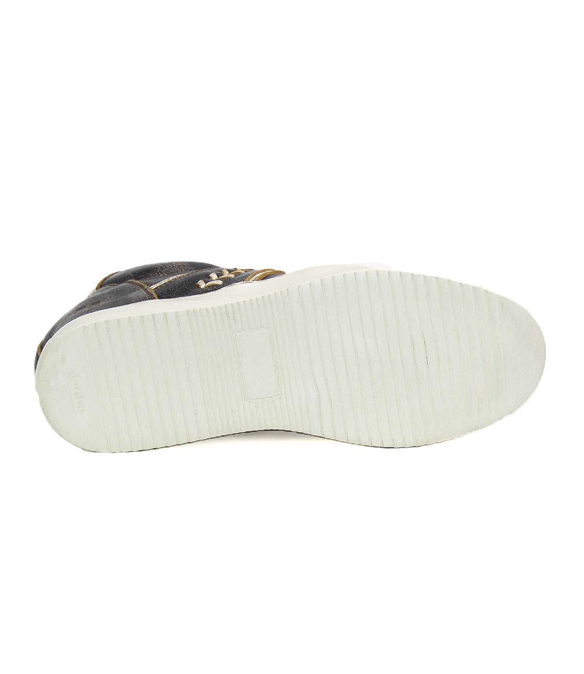 Here's a bottom view of the Andromeda, a black high-top sneaker from Bed Stu, featuring a white rubber sole. The sole displays horizontal grooves and shows signs of wear in certain areas, particularly towards the middle, accentuating its street-smart design.