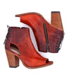 A pair of Angelique red leather boots with a wooden heel by Bed Stu.
