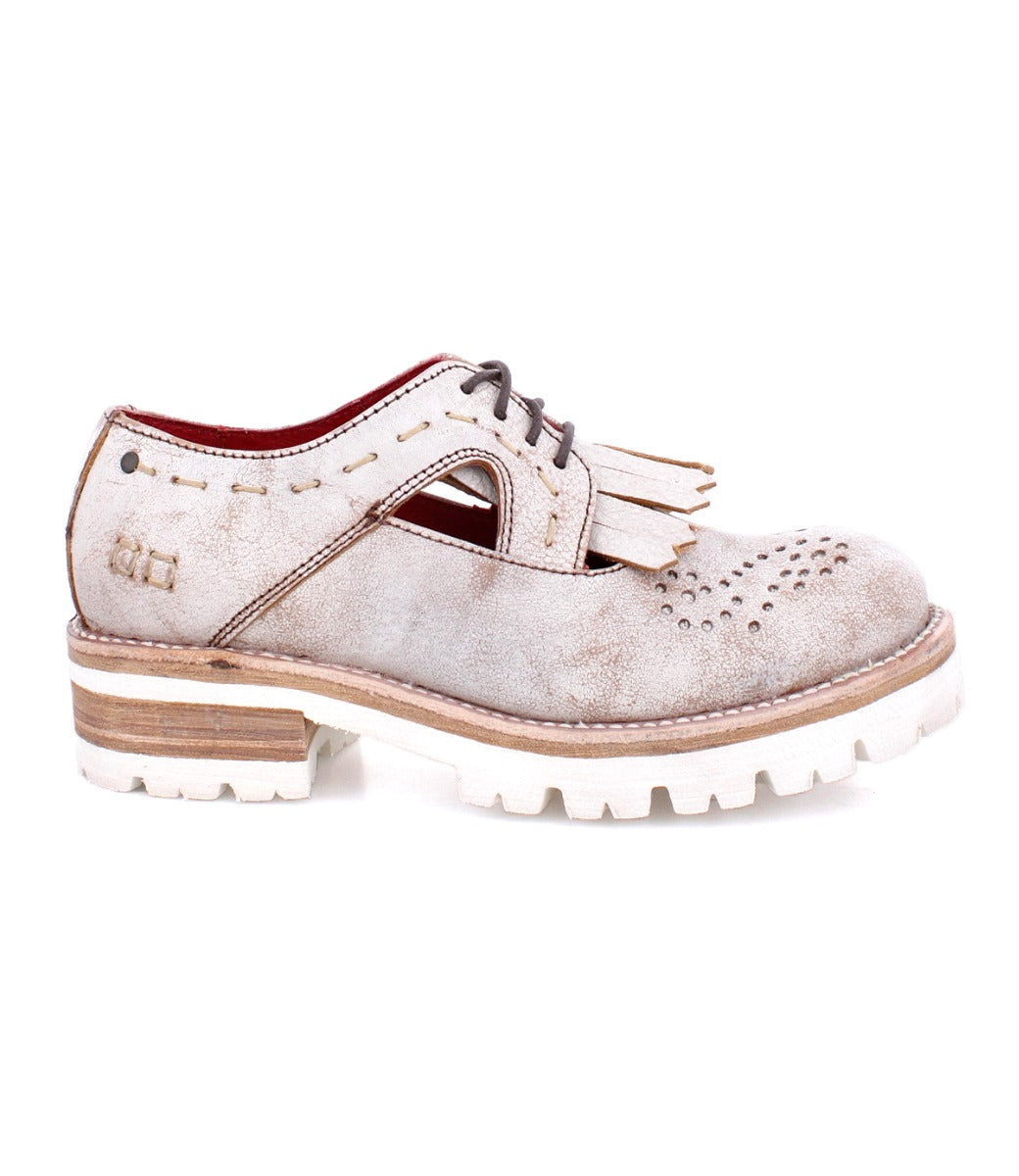 An Anise shoe from the Bed Stu brand with tassels and a white sole.