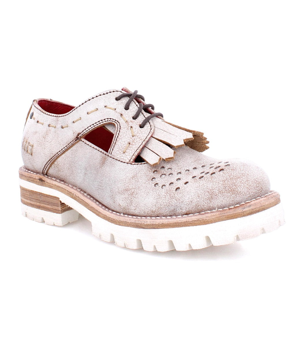 An Anise shoe by Bed Stu with tassels and a white sole.