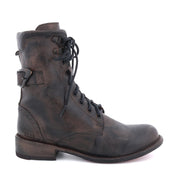 A women's black leather boot with metal buckles called Anne by Bed Stu.