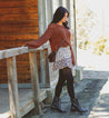 A women wearing black leather boot with metal buckles called Anne by Bed Stu.