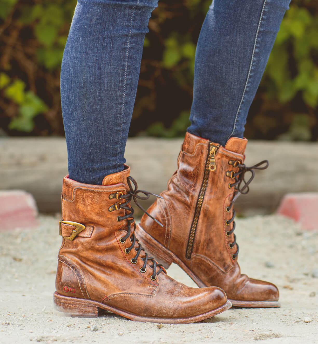 A woman's legs standing in a pair of Bed Stu Anne boots.