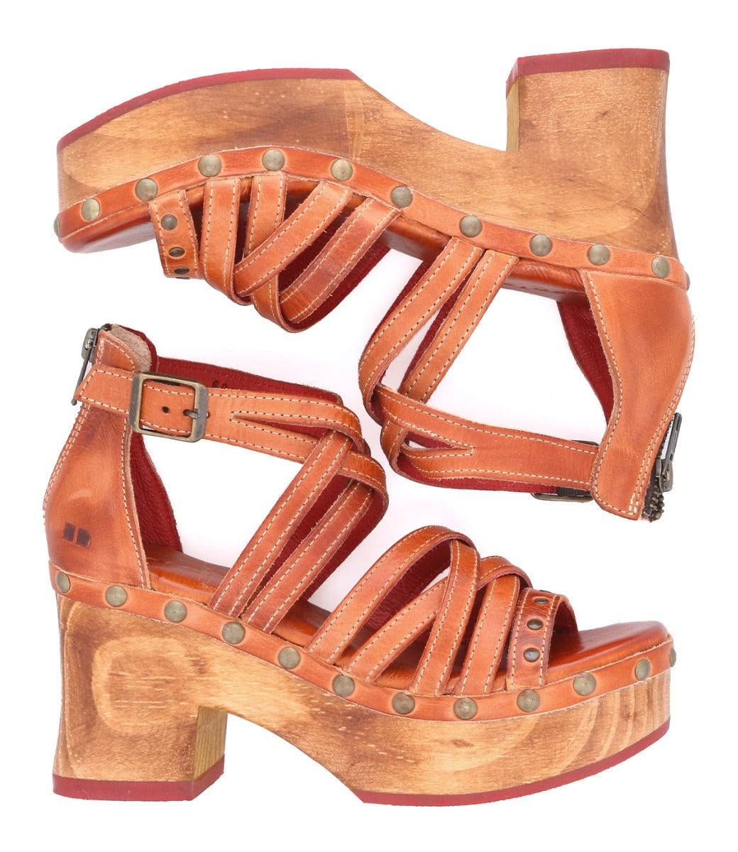 A pair of Antonelli wooden sandals with Bed Stu straps on them.