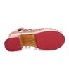 A pair of Antonelli sandals with red soles by Bed Stu.