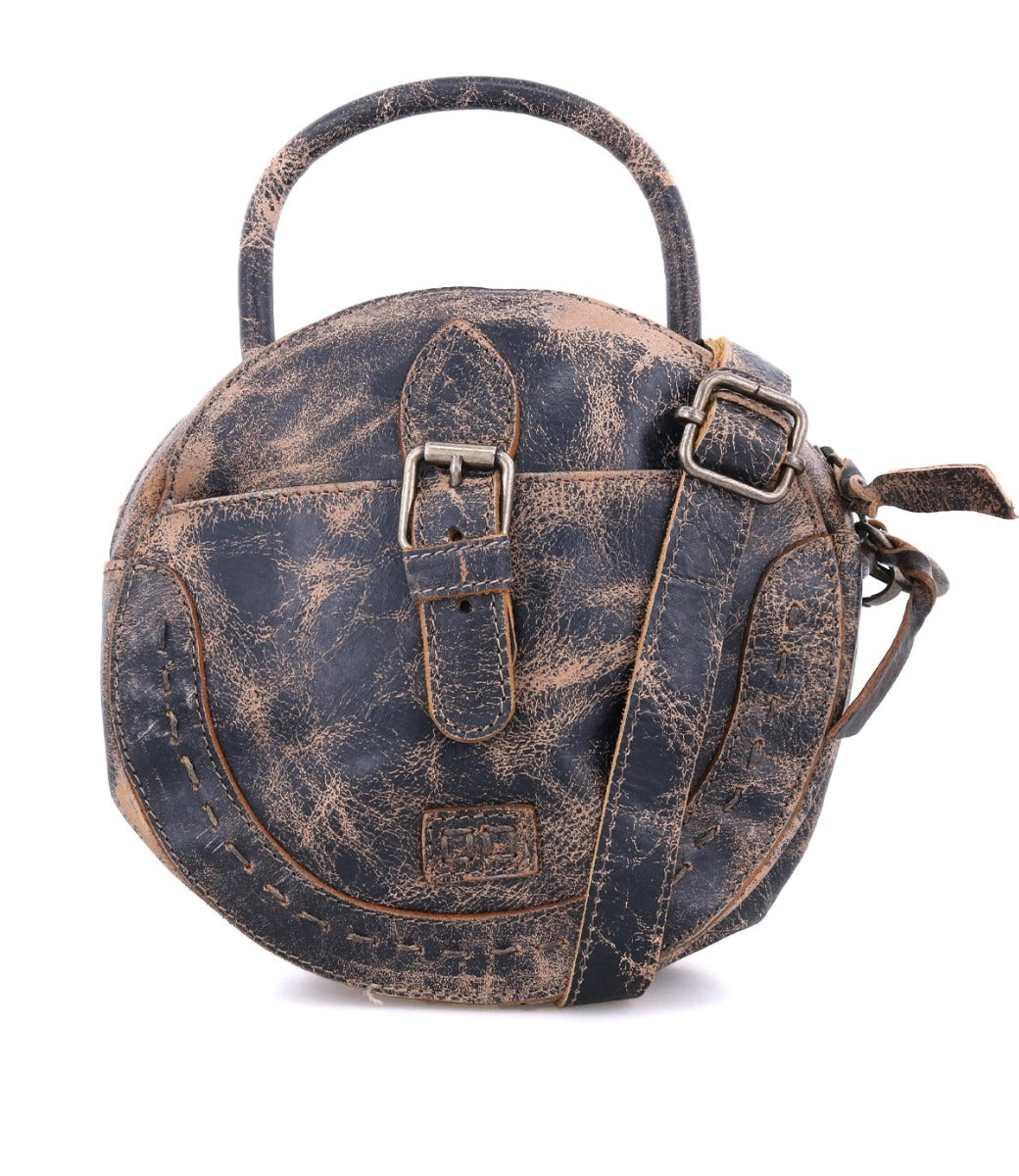 A round leather Arenfield bag with a strap and buckle, made by Bed Stu.