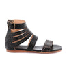 A women's black sandal with straps and buckles called Artemis by Bed Stu.