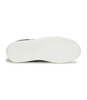 The image showcases the bottom view of the Azeli low-profile sneaker by Bed Stu, featuring a white rubber sole with a textured grip pattern that seamlessly blends style and comfort.