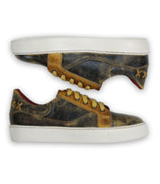 A pair of worn Azeli low-profile sneakers by Bed Stu, featuring brown and black leather with durable white outsoles, positioned side by side with one sneaker lying on its side and the other upright.
