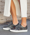A woman wearing an Azeli skirt and Bed Stu sneakers.