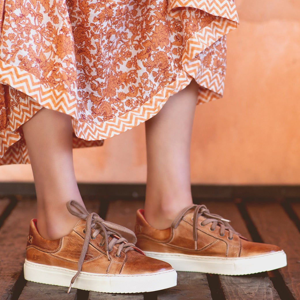 A woman wearing an Azeli dress and Bed Stu brown sneakers.