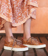 A woman wearing an Azeli dress and Bed Stu brown sneakers.