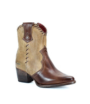 The Baila II by Bed Stu is a tan and brown leather cowboy boot featuring a mid-height chunky heel, decorative stitching, and western-inspired style. This pointed toe beauty boasts intricate whipstitch accents for added flair.