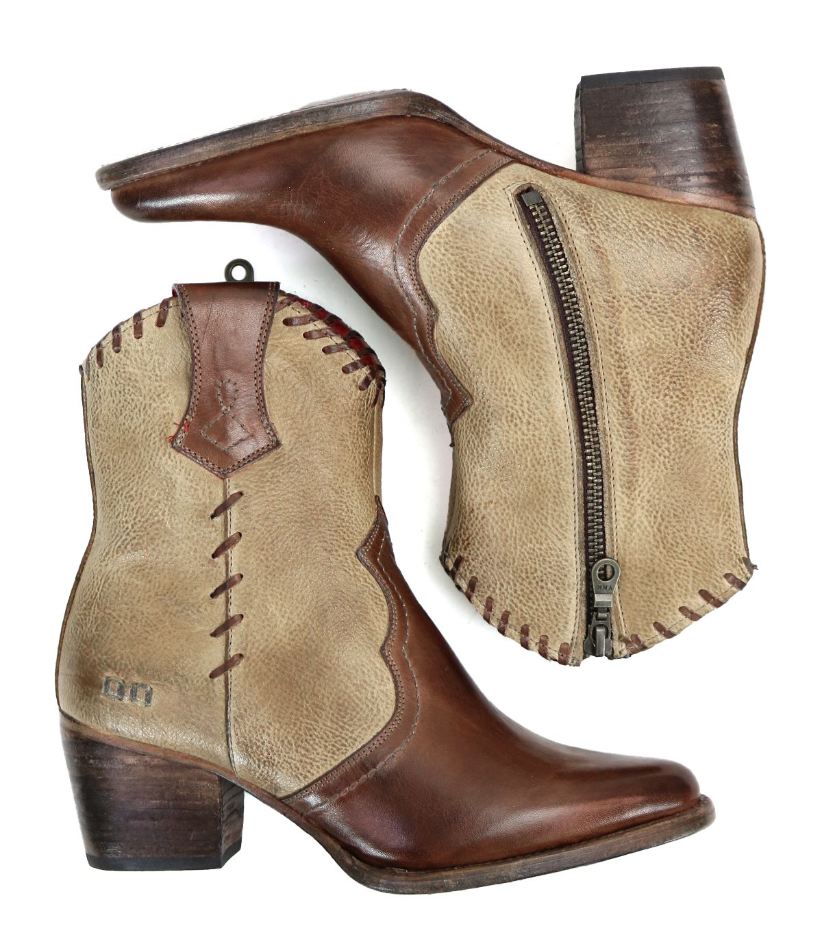The Baila II ankle cowboy boots by Bed Stu are designed in a brown and beige combination, featuring a side zipper. They are decorated with whipstitch accents and intricate stitching details, showcasing their western-inspired style against a white background.