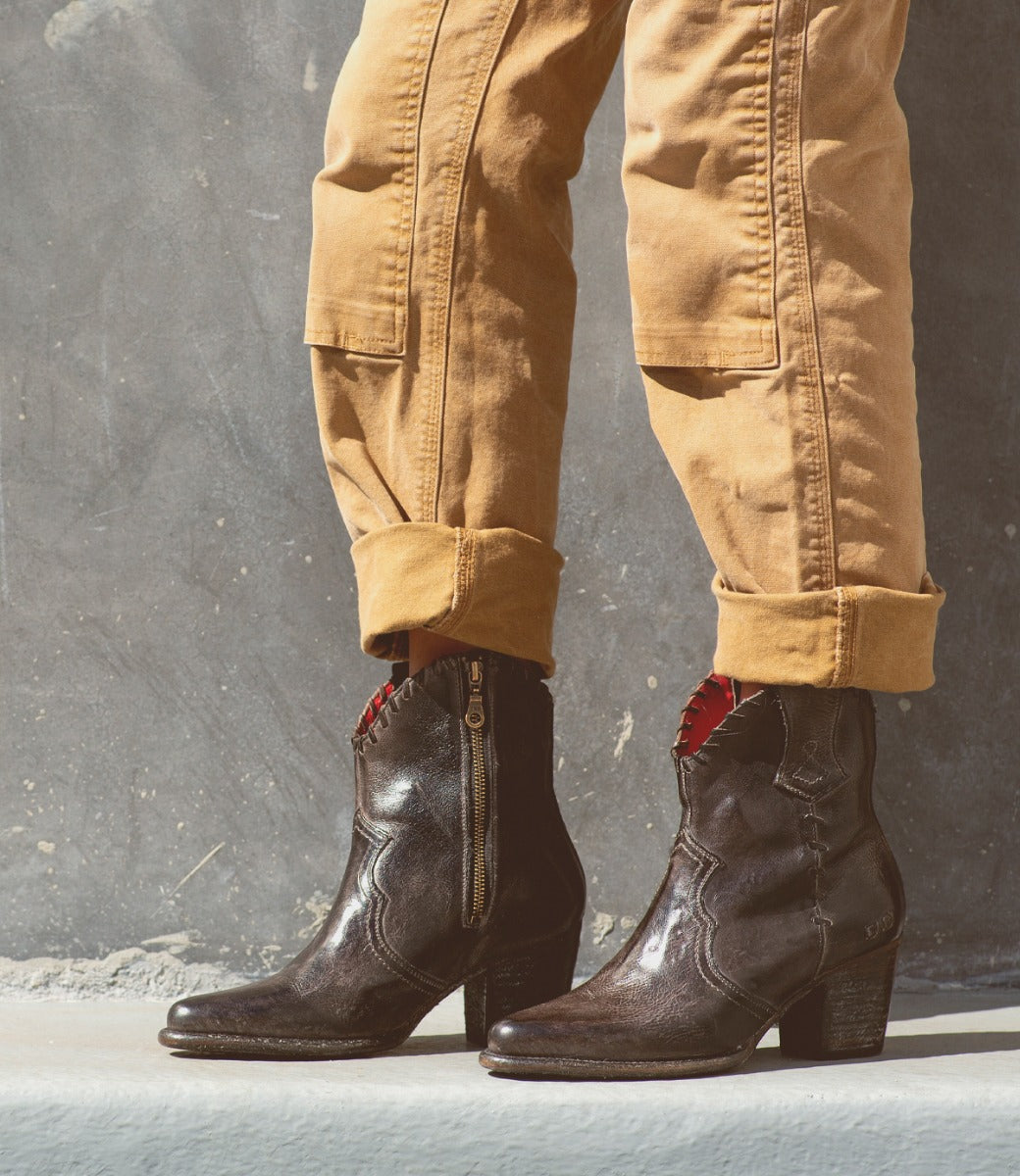 A woman wearing Bed Stu Baila II boots and a pair of khaki pants.