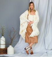 A woman wearing a sweater and Baila II boots by Bed Stu.
