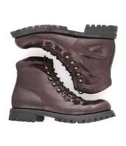 A pair of Bed Stu brown leather hiking boots on a white background.