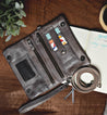 A Bed Stu Bayshore leather wallet on a table next to a notebook.