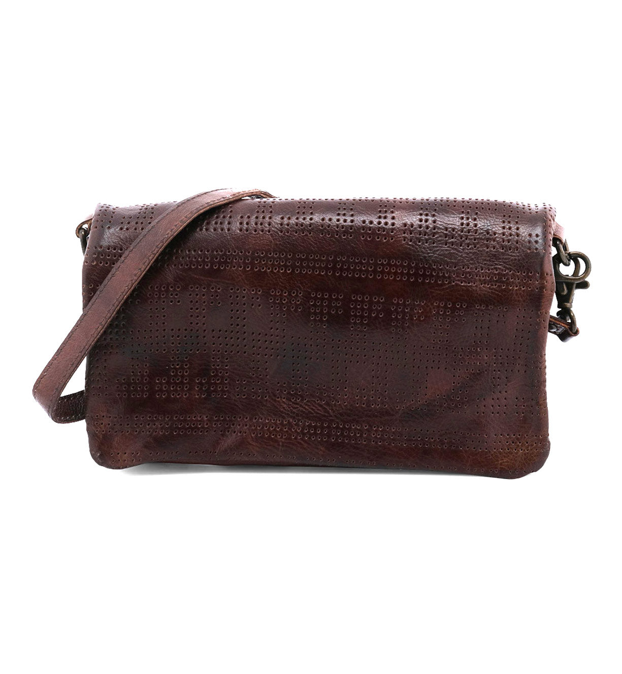 The Bed|Stü Bayshore is a brown leather crossbody bag featuring a perforated pattern and a long strap; displayed against a white background, this versatile clutch seamlessly transitions from day to night.