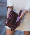 A woman holding a Bayshore wallet by Bed Stu.