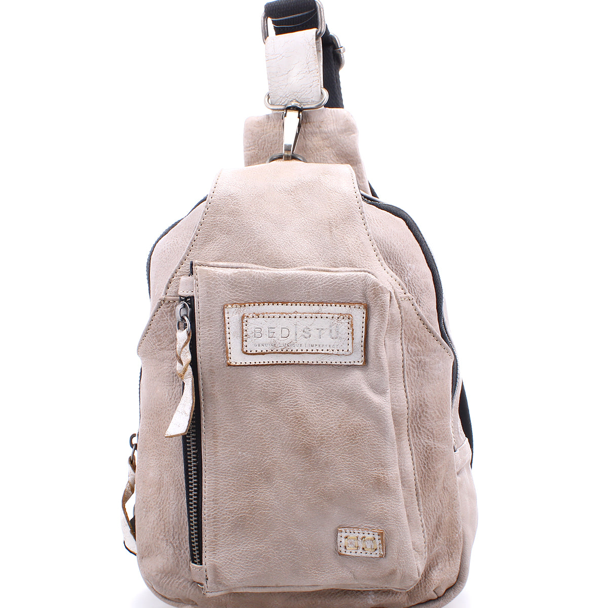 A Beau leather sling backpack with a zipper on the side, perfect for hands-free activities.