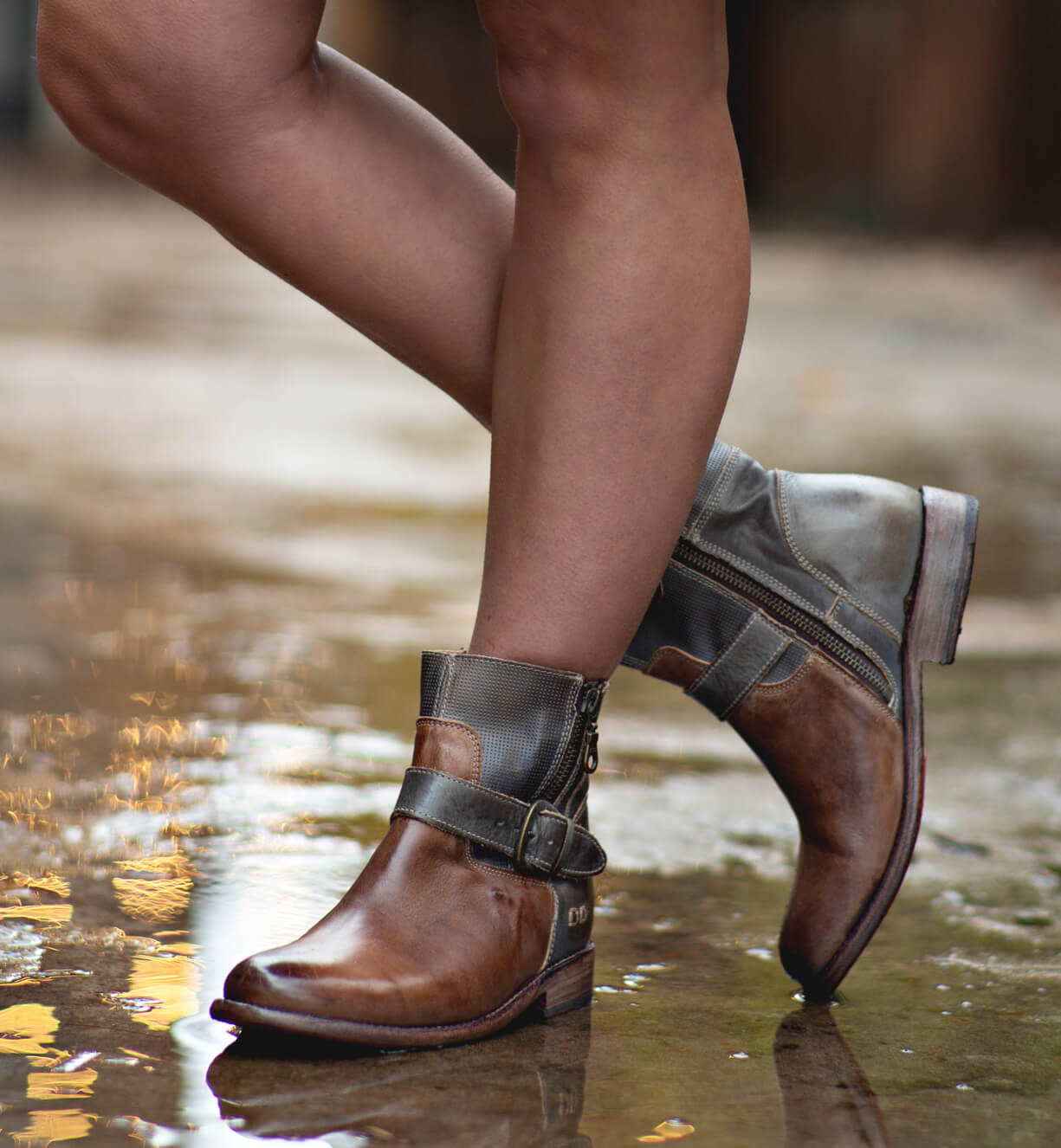 A woman wearing a pair of Bed Stu Becca taupe leather boots.