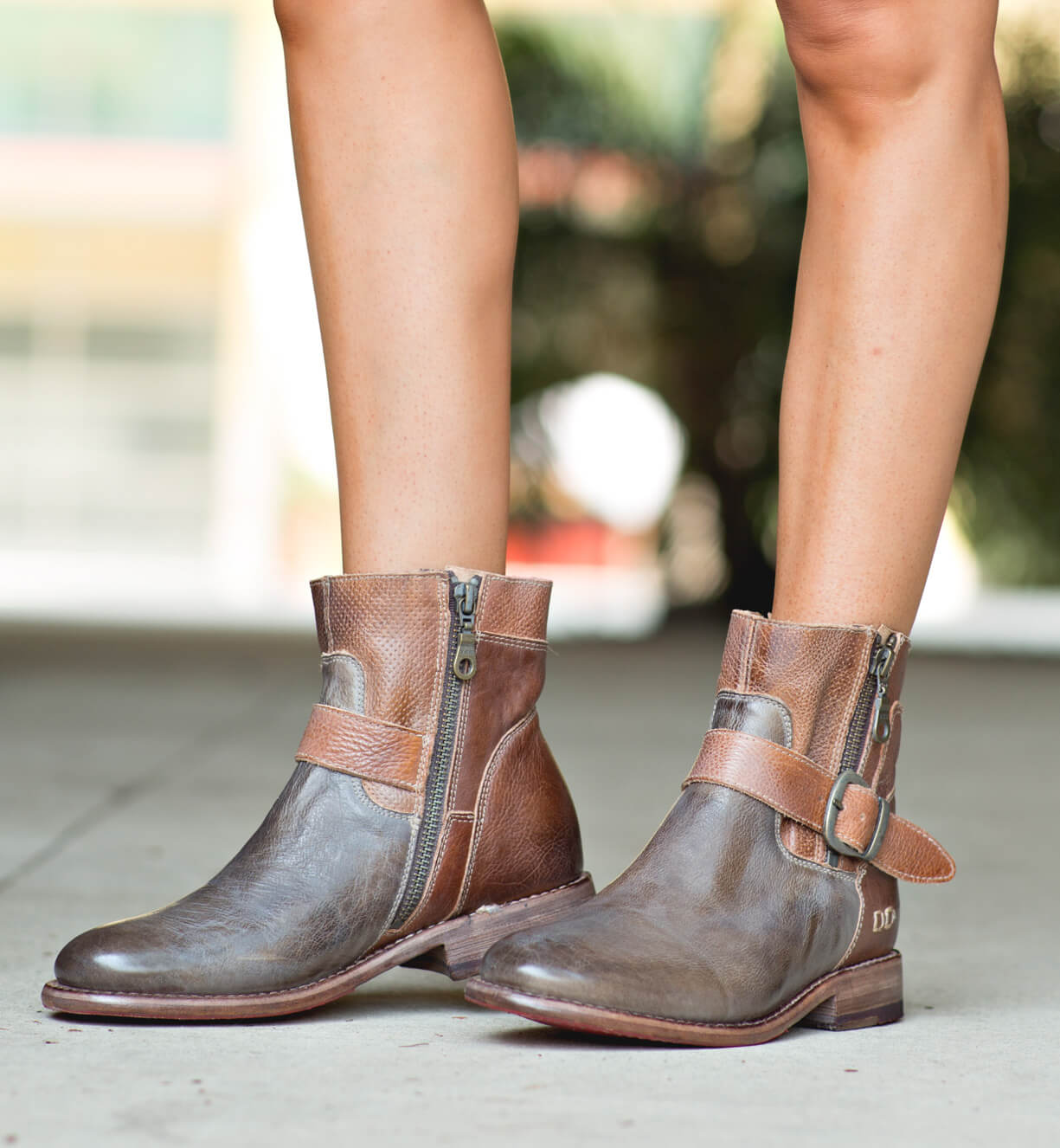 A woman wearing a pair of Bed Stu Becca tan leather boots.