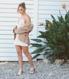 A woman wearing a Bellatrix II women's white sandal by Bed Stu.