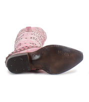 The "Betting" by Bed Stu is a pink Western boot made from vegetable-tanned leather, featuring cutouts, studs, and a wooden heel with an upward-facing sole.
