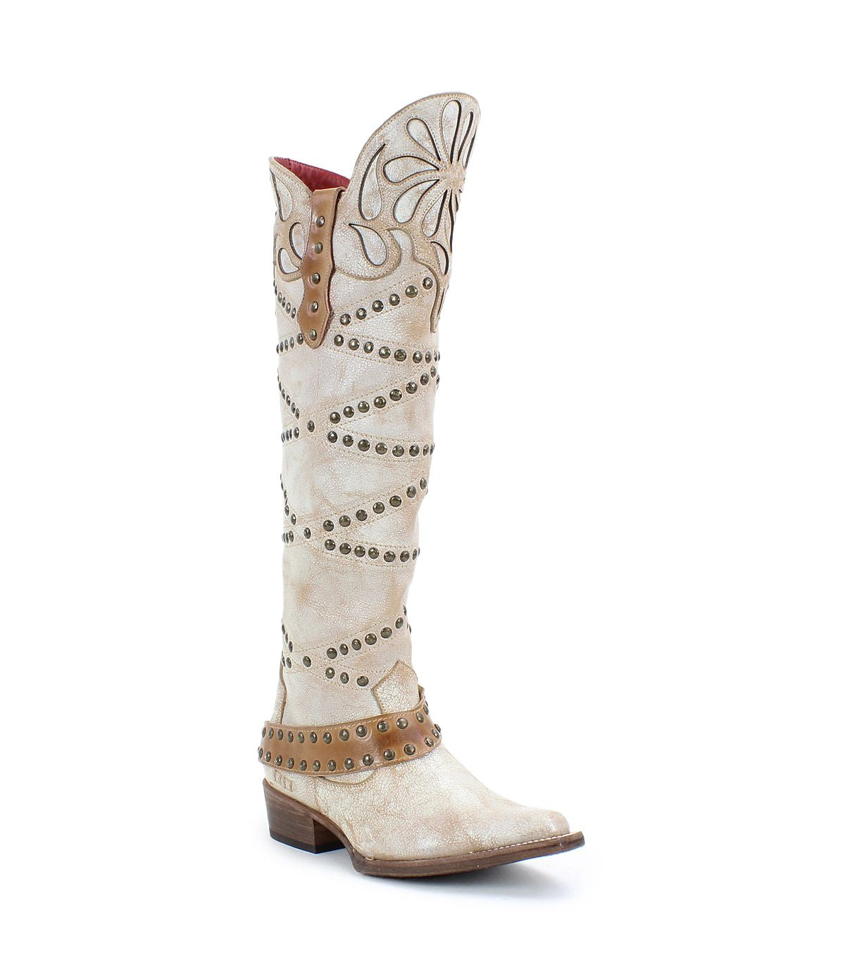The Bed Stu Betting is a tall white Western boot made of vegetable-tanned leather, featuring decorative stitching, studs, a flower pattern near the top, a low heel, and an elegant harness strap for added style.