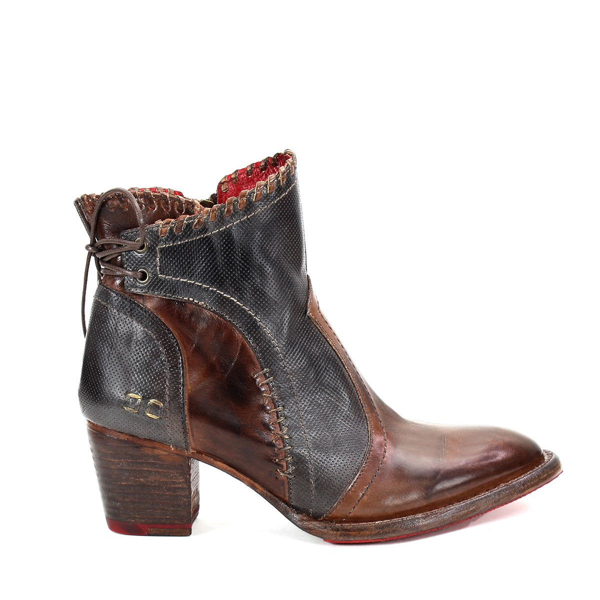 Introducing the Bia boot by Bed Stu: A handcrafted brown leather bootie with a textured black upper, decorative stitching, and a medium stacked wooden heel. This comfortable boot features a striking red lining and elegant lace-up detail at the back.