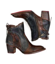 A pair of Bed Stu Bia handcrafted brown leather booties, featuring stacked heels, side zippers, and decorative stitching, positioned on a white background.