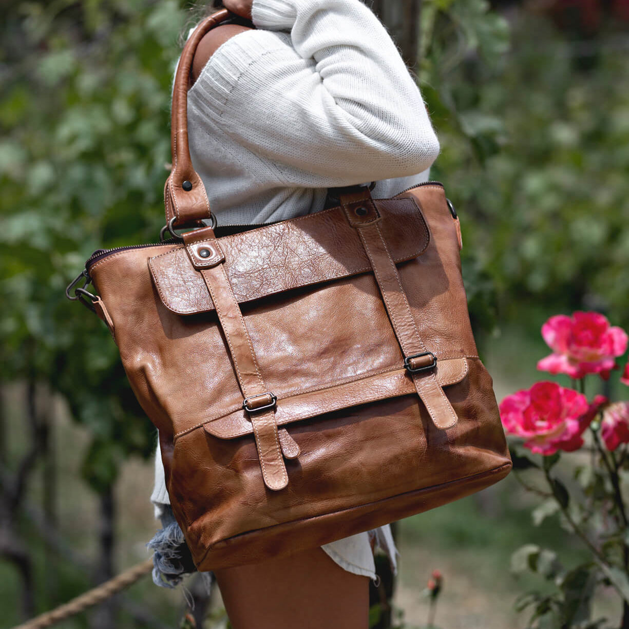 A woman holding a Bed Stu Big Fork tote bag.